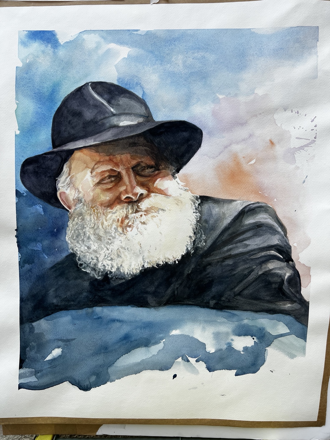 Watercolor portrait of the Lubavitcher Rebbe in a black hat against a blue sky